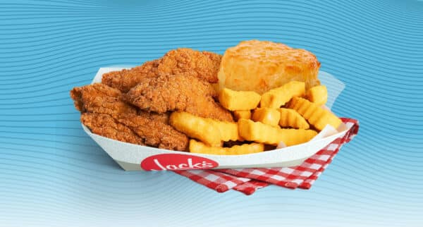 Jack’s Catfish Basket with crispy fried catfish, crinkle cut fries, and a biscuit served in a branded paper tray on a red gingham cloth against a blue wavy background.