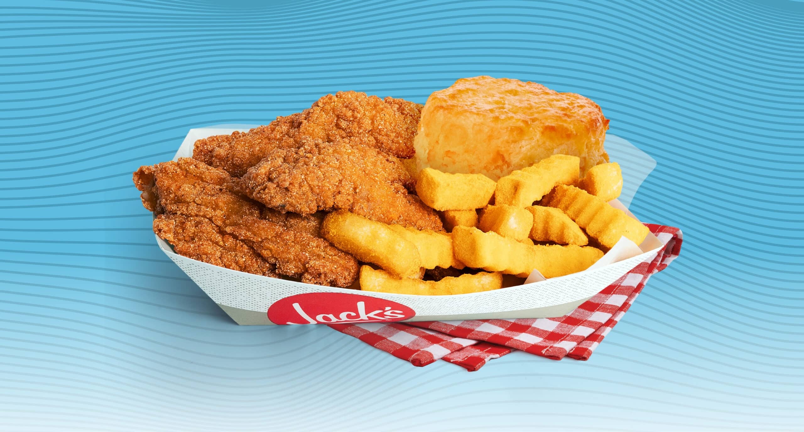 Jack’s Catfish Basket with crispy fried catfish, crinkle cut fries, and a biscuit served in a branded paper tray on a red gingham cloth against a blue wavy background.