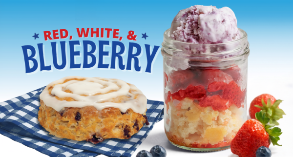 A blueberry biscuit with white icing sits on a blue gingham napkin beside a mason jar layered with fruit and blueberry dessert, strawberries, and blueberries. Text reads “Red, White, & Blueberry.”